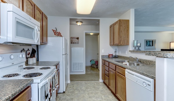 kitchen area with ample counter space and access to a hallway